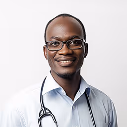 Smiling male doctor wearing glasses, a white coat, and a stethoscope around his neck against a plain white background.