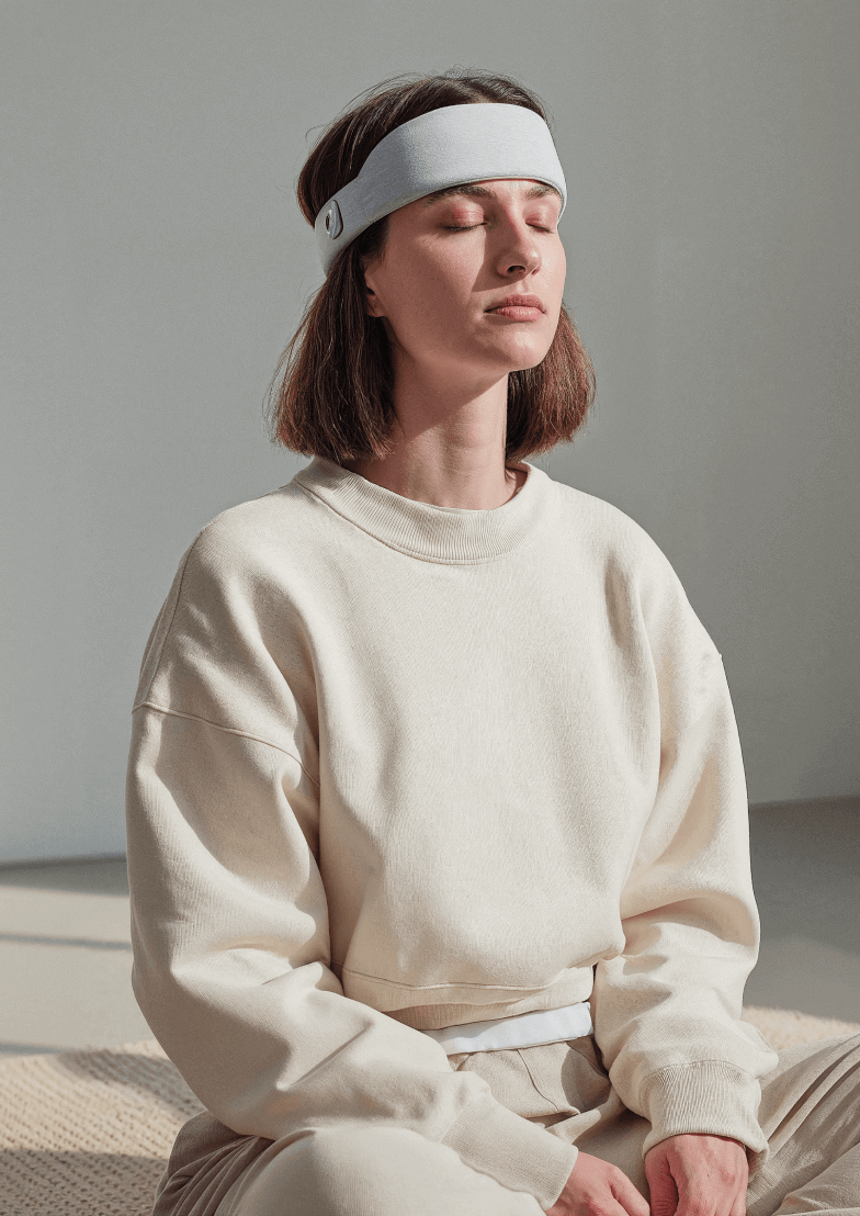 Woman Meditating Smart Headband - Longevity Webflow Template | Brix Templates