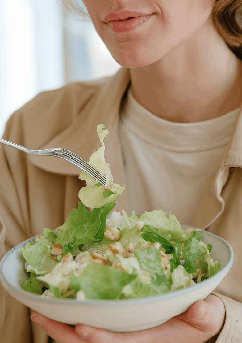 Woman Eating Healthy Green Salad - Longevity Webflow Template | Brix Templates